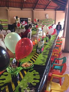 a long table topped with lots of balloons