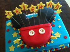 a mickey mouse birthday cake is decorated with fondant stars and balloons for the ears