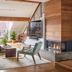 a living room with wood paneling and a fireplace