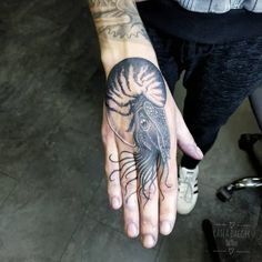 a person with a tattoo on their hand