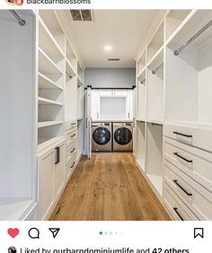 an empty laundry room with white cabinets and wood floors