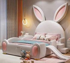 a bedroom decorated in pink and white with a large bunny head on the wall above the bed