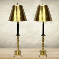 pair of brass table lamps with black and gold shades