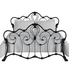 an iron bed frame with white sheets and black wrought designs on the headboard, along with two pillows