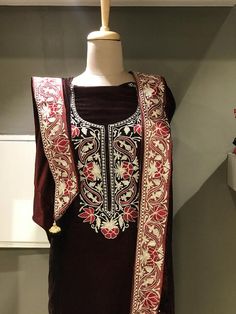 A stunningly marvellous velvet dress. This suit features intricate zari/tilla embroidery on the shirt neck, on sleeves and 4 sided embroidered border on the dupatta.- - - - - - - - - - - - - - - - - - - - Product Details- Condition Brand New - Dupatta Size: 88" X 38" (225 cms X 96.52 cms) approx.- Colour: MarronF A B R I CShirt: VelvetDupatta: VelvetBottom: Velvet or Indian Crepe (whichever you prefer, let us know.)F I N I S HUnstitched/Semi-StitchedYou can get it stitched locally.47+ inches of Festive Velvet Straight Kurta, Elegant Embroidered Dress With Dabka For Festive Occasions, Fitted Velvet Dresses For Designer Wear, Velvet Fitted Dress For Designer Wear, Traditional Designer Dress With Multicolor Embroidery, Designer Velvet Kurta For Diwali, Designer Multicolor Embroidery Dresses For Festivals, Designer Festival Dresses With Multicolor Embroidery, Fitted Velvet Dress With Resham Embroidery