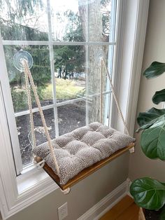 a window sill with a cushion hanging from it