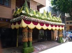 an elaborately decorated gazebo on the side of a street in front of a building