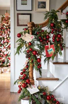 christmas decorations on the banisters and stairs in a home decorated with red ornaments