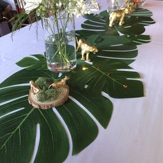 the table is set with flowers and figurines