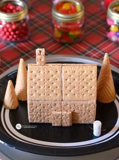 a black plate topped with crackers and cones