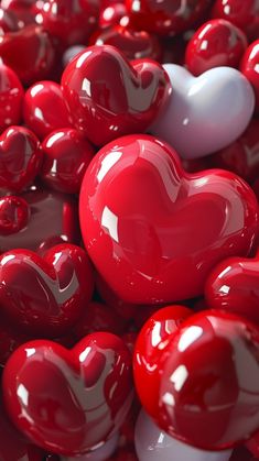 red and white heart shaped candies are arranged in the shape of hearts on display