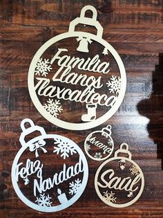 christmas ornament cutouts are displayed on a wooden surface with the words santa, los angeles, and hollywood written in white