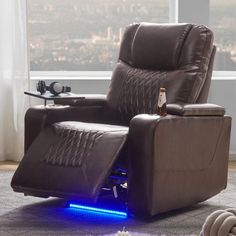 a recliner chair with lights on it in front of a window overlooking the city