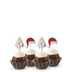 three cupcakes with white frosting and christmas decorations