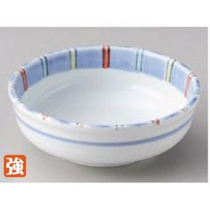 a white bowl with blue and red stripes on the rim, in front of a gray background