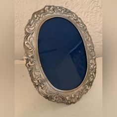 an ornate silver frame sitting on top of a table