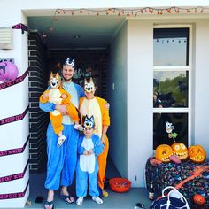 a man and two children are dressed up as cats