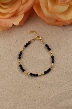 Black Onyx Bead Bracelet, 14Kt Gold Filled - Gemstone Jewelry Gifts for Women Adjustable 7 inches - 8 inches Black and gold create a perfectly elegant combination. This bracelet is easy to match with any outfit, adding an effortless elegance. You will love the bright sparkle of the gold beads, and the flashes from the dark surfaces of the faceted Onyx beads.  What is Gold Filled? Gold filled jewelry has a layer of solid gold that is 100 times thicker than that of gold plated jewelry. It is hypoallergenic, resistant to tarnish, and will not chip or fade over time. Gold filled has an appearance nearly identical to solid gold, but with a more affordable price. It is highly durable and with proper care will last a lifetime. Browse my shop: ALLDANAE.etsy.com Dainty Black Beaded Bracelets For Gift, Gold Beaded Bracelets With Onyx Gemstones, Gold Onyx Beaded Bracelets With Black Beads, Gold Onyx Beaded Bracelets With Gemstones, Dainty Beaded Gold Bracelet, Black Bracelet With Gold Beads, Gold Crystal Bracelet With Round Beads And Beaded Chain, Gold Crystal Bracelet With Beaded Chain, Onyx Beaded Bracelets With Round Beads