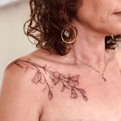 a woman's chest with flowers on it and the word love written in cursive writing