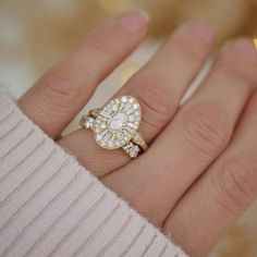 a woman's hand with a diamond ring on it