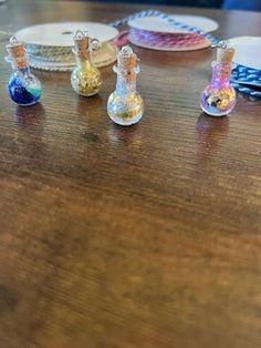 small glass vases sitting on top of a wooden table