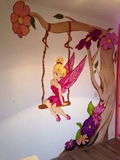 a bedroom decorated with fairy tinkerbells, flowers and a tree branch hanging from the ceiling