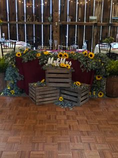 the table is set up with sunflowers and greenery for an outdoor wedding reception