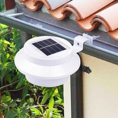 a solar powered light on the side of a house