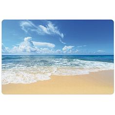 an ocean scene with waves crashing on the beach and blue sky in the back ground