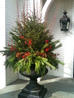 winter front porch decorating evergreen urn project with pine cones, berries and holly