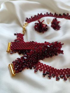 Exclusive handmade jewelry set "Burgundy Wine". Introducing this exclusive handmade necklace, bracelet and earrings set, woven from high-quality Japanese seed beads and natural garnet. The necklace is woven from high-quality Japanese seed beads in burgundy color and decorated with irregularly shaped natural garnet beads. The elegant clasp is plated with natural gold. The necklace measures approximately 44.0 cm (17.32 in) in length. Bracelet. The irregularly shaped garnet beads are sewn onto a be Garnet Jewelry Set, Burgundy Wine, Natural Gold, Garnet Jewelry, Burgundy Color, Wedding Jewelry Sets, Christmas Jewelry, Handmade Necklaces, Jewelry Set