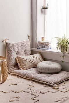 a window sill filled with pillows and plants