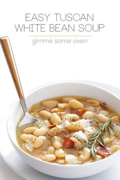 a bowl of white bean soup on a plate with a spoon in it and the title easy tuscann white bean soup