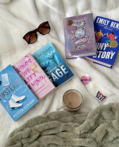 some books and sunglasses are laying on a blanket