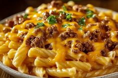 a white bowl filled with macaroni and cheese on top of a wooden table