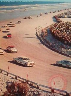 an old photo of cars racing on the beach