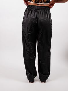 Make an entrance in this streetwear inspired track pant. Our Keep It Low Key Track Pant features an elastic adjustable waistband designed to sit at your waist to achieve the on-trend streetwear inspired look. Side pockets that leads in a straight leg! This lightweight piece is so versatile, you will have effortless ways to style this pants! Color: Black Relaxed Fit Fit True to Size Elasticized Waistline with Adjustable Drawstring Side Pockets No Stretch No Closures Not Lined Inseam: 27" - 29" Ca Track Pant, Adjustable Waistband, Denim Flares, Striped Cardigan, Mini Wrap Dress, Women Clothing Boutique, Pants Color, Shoulder Sweater, Low Key