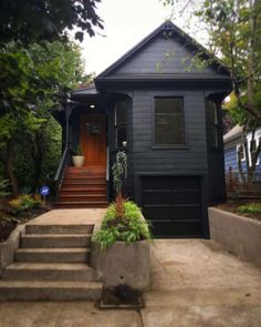 a black house with steps leading up to it