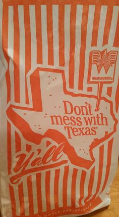 an orange and white bag with the word don't mess with texas on it