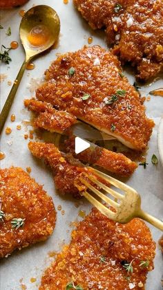 some food is laying out on a table with spoons and sauce in the middle