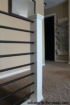 an empty room with a towel rack and mirror