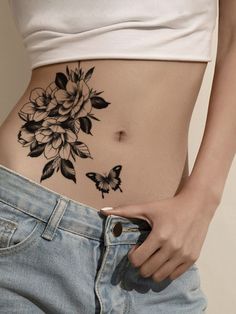 a woman's stomach with flowers and butterflies on the side, showing her belly