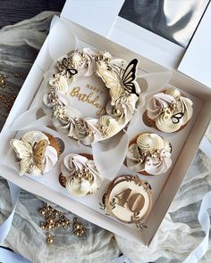 a box filled with cupcakes sitting on top of a table