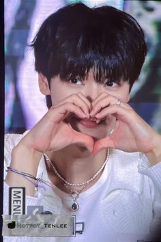 a person making a heart shape with their hands in front of his face and the words i love you written on it