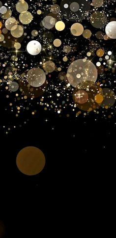 a black background with gold and white circles