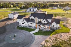 an aerial view of a large home in the middle of a rural area with lots of grass