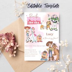 a birthday card with cartoon characters on it next to some flowers and a brown envelope