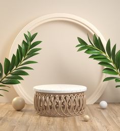 a white table and some green plants in front of a round wall hanging on the wall