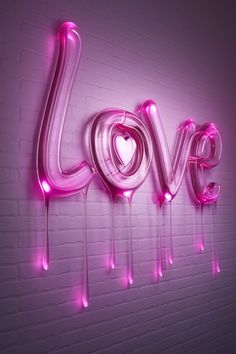 the word love is spelled with neon lights