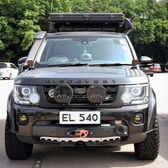 a black land rover vehicle parked in a parking lot